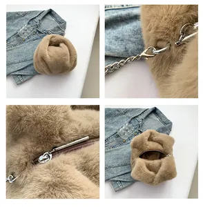 Detail view of khaki plush bucket bag showing metal chain, zipper, and soft faux fur texture