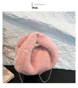 Detail of pink faux fur bucket bag with knotted handle and silver chain strap