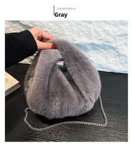 Detail view of a gray plush bucket bag showing soft faux fur texture and silver metal chain