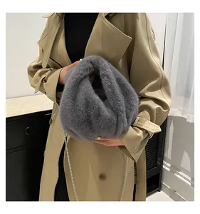 Close-up of soft grey faux fur plush bucket bag with elegant thin metal chain strap