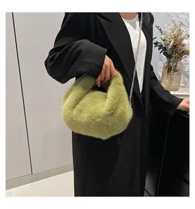 Close-up of soft avocado green plush bucket bag with elegant silver chain strap