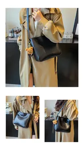 Détail du sac cabas en similicuir noir avec logo FASHION & BAGS et breloque ours marron