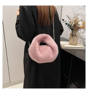 Pink plush chain bag detail on model with soft faux fur texture for winter fashion