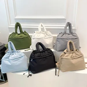Soft padded nylon quilted handbags in multiple colors featuring drawstring and zipper closures