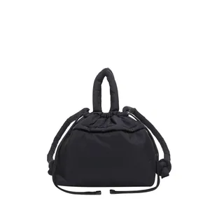 Large black padded puffer tote bag with drawstring closure and quilted soft material