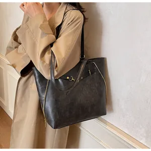 Dettaglio della borsa tote vintage con cerniere dorate e pelle sintetica testurizzata