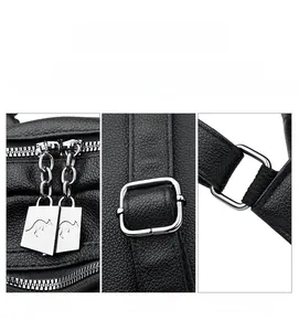 Close-up of silver hardware, kangaroo zipper, and lychee leather on black backpack