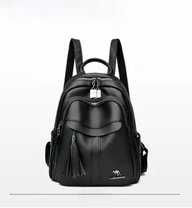 Detailed view of black textured faux leather backpack with tassel and kangaroo logo