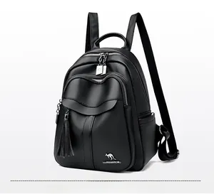 Detail view of black faux leather backpack with litchi texture and tassel accessory