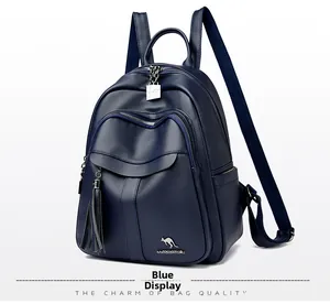 Detail view of blue pebbled leather backpack featuring metal tassel and kangaroo logo