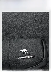 Detailed macro view of litchi texture black leather and silver metal kangaroo logo icon