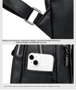 Detail of reinforced triangular shoulder strap and side pocket on black leather backpack