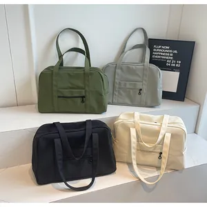 Detailed view of large travel tote bags in green, grey, black, and beige colors
