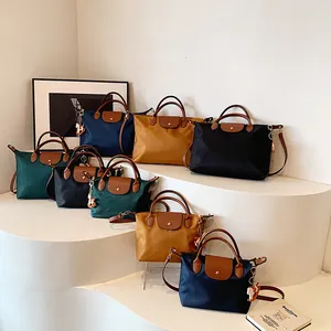 Contrast nylon tote bags in blue, yellow, and black with leather handles and horse charms