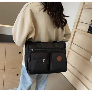 Black vintage large capacity tote bag with front zipper pockets and adjustable strap