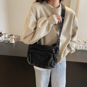 Black washed denim crossbody bag with multiple zip pockets for travel and school use