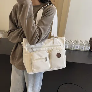Minimalist cream white high-capacity tote bag with dual front pockets for outdoor and fitness