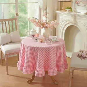 Detail of pink gingham tablecloth with ruffle edges for romantic dining decor