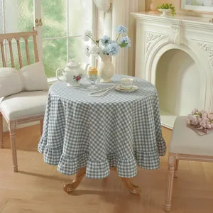 Round blue and white gingham washed cotton tablecloth with decorative ruffle edge detail