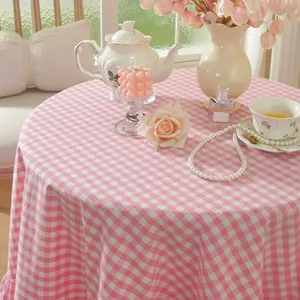 Close-up of pink and white checkered tablecloth with elegant ruffled edge and soft texture