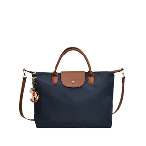 Large navy nylon tote bag with brown leather handles and a horse charm detail