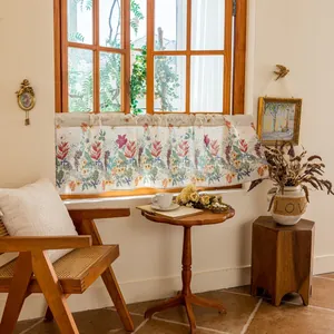 Detail of tropical floral café curtain with rod pocket design on vintage wooden cabinet
