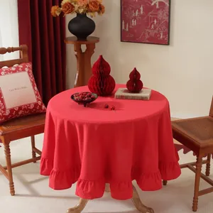 Red circular wedding tablecloth with elegant ruffle edges and high-quality drape texture