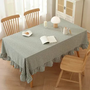 Close-up of green and white plaid cotton tablecloth featuring elegant ruffled edges