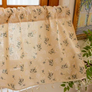 Detailed texture of beige floral kitchen curtain with boho tassels and botanical patterns