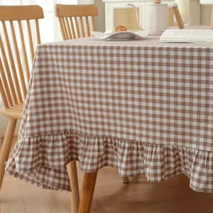 Close-up of brown and white checkered tablecloth with decorative ruffled edge detail