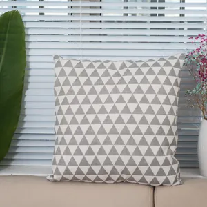 Close-up of grey and white geometric triangle pattern on linen pillowcase texture