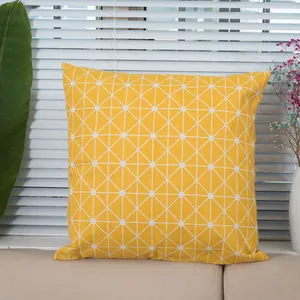 Close-up of yellow cotton linen pillowcase showing textured fabric and white grid pattern