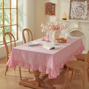 Detail of pink and white checkered tablecloth featuring elegant ruffled lace edges