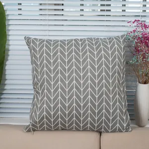 Linen plaid throw pillow cover with grey herringbone pattern on a cozy beige sofa