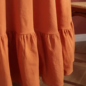 Close-up of ruffled hem with white stitching on high-quality terracotta table cloth
