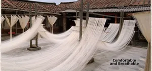 Traditional outdoor drying of raw natural linen fibers on wooden frames for tablecloths
