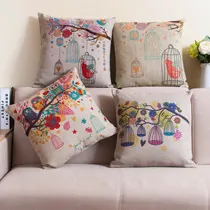 Close-up of rustic cotton linen cushion covers with vintage bird and floral prints