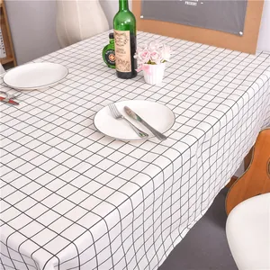 Macro shot of modern black and white plaid tablecloth with elegant dining table setting