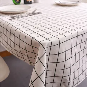 Detailed texture of black and white plaid tablecloth with natural linen fabric draping