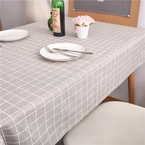 Detail of grey and white checkered linen tablecloth with a clean hem and smooth drape