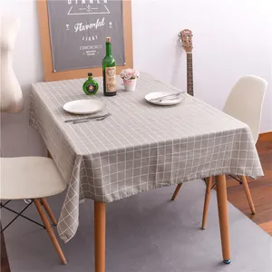 Detail of grey and white checkered tablecloth with natural drape on a rectangular table