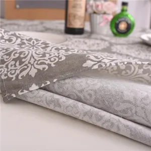 Détail d'une nappe en coton et lin avec motif damassé et finitions de couture