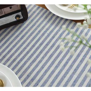 Close-up of blue and white striped cotton linen table runner with detailed woven texture