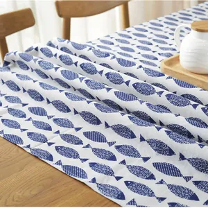 Japanese style blue fish pattern cotton linen tablecloth on a wooden table