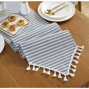 Detailed macro view of the blue and white striped cotton linen table runner with fringes