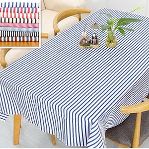 Close-up detail of the linen texture and blue vertical stripes on a rectangular tablecloth