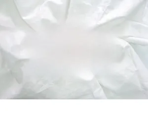 Close-up of minimalist white pleated cotton fabric texture for photography backgrounds