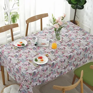 Close-up of French floral tablecloth featuring pink roses and vintage typography
