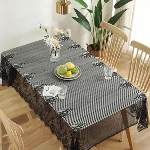 Detail of Nordic striped tablecloth with wide black lace edges and floral embroidery