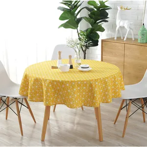 Close-up of yellow round cotton linen tablecloth with white geometric triangle pattern